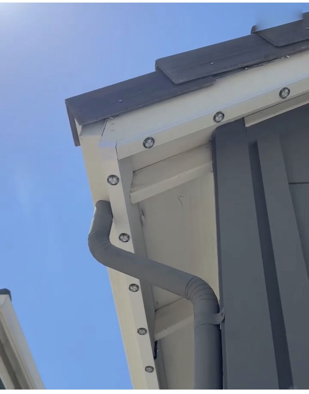 Close-up of a permanent lighting fixture mounted on a roofline